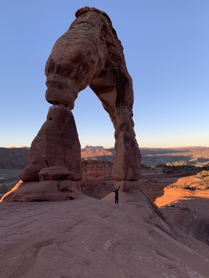Delicate Arch with person underneath and scenic view