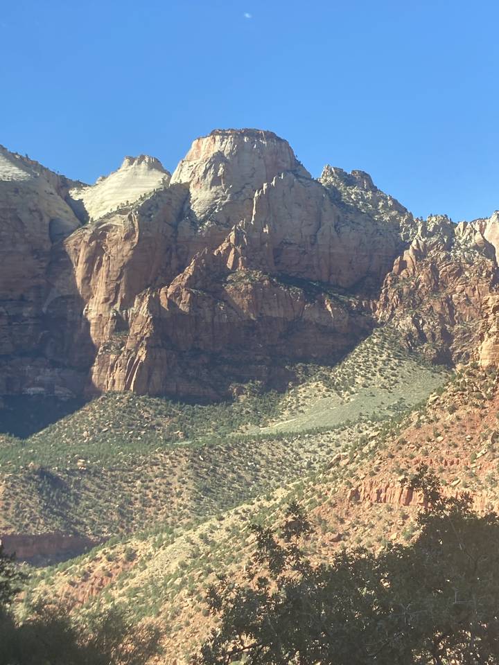 Rocky mountain landscape with steep cliffs under clear skies.