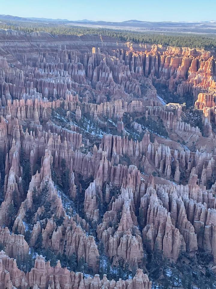 Rock formations at a national park with sunlight in the background.