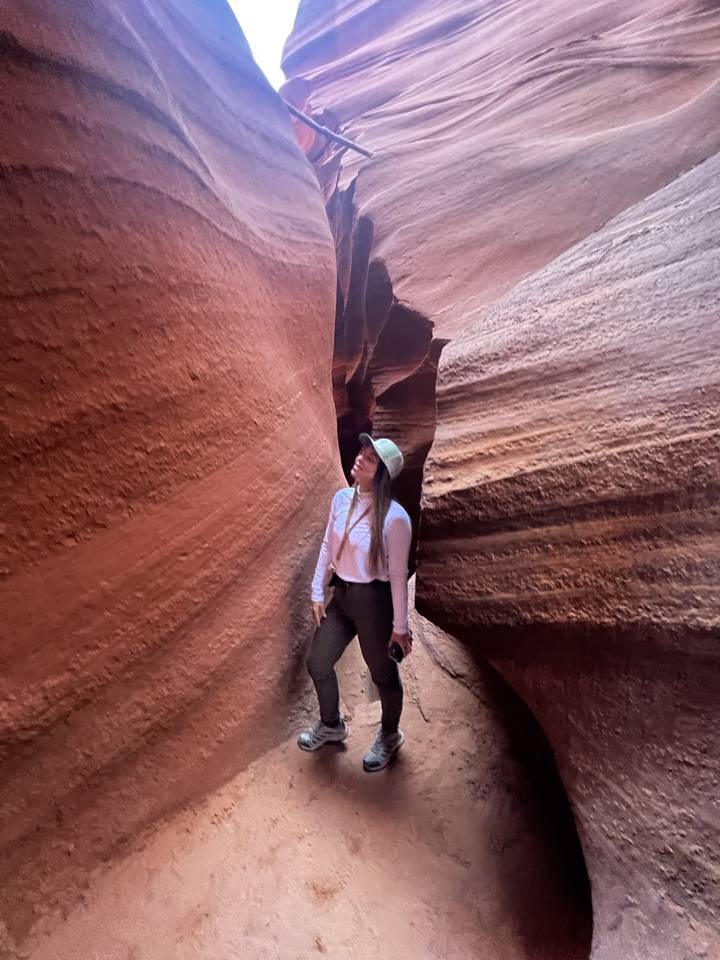Tourist exploring narrow canyon walls.