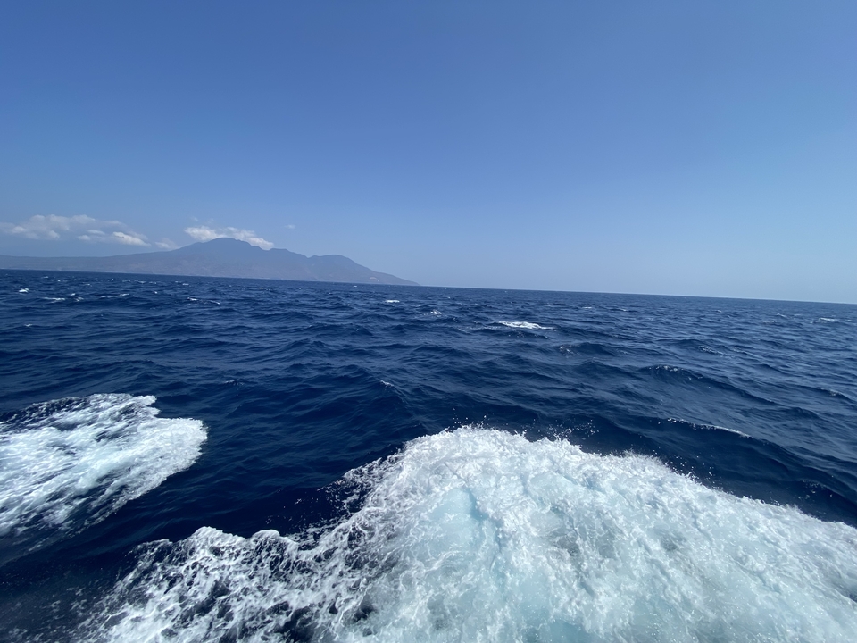 Open sea with mountains in the background