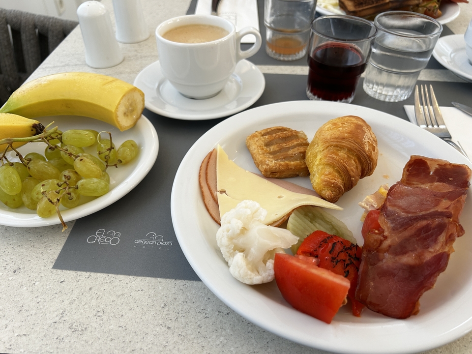 Breakfast spread with fruits, pastries, and beverages.