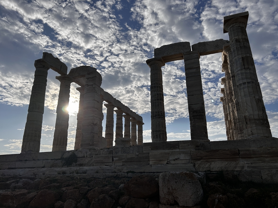 Ancient ruins with sun shining through the columns.