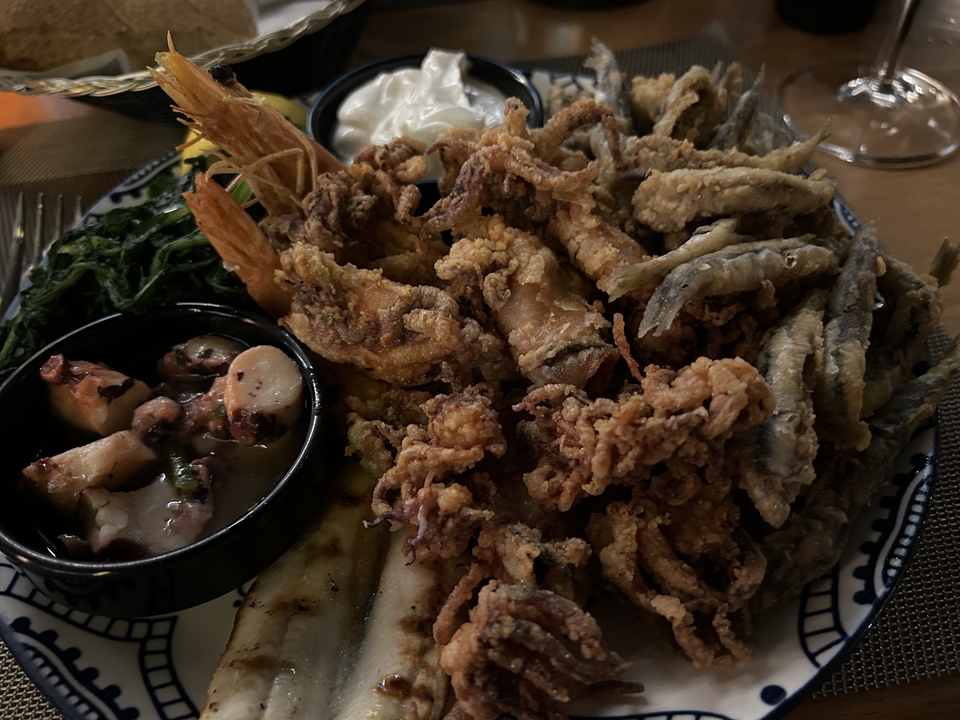 Plate of assorted fried seafood with garnish.