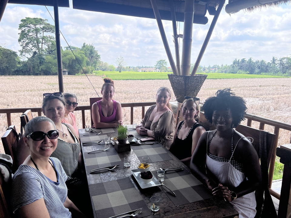 Group of women dining at a restaurant with a field view.
