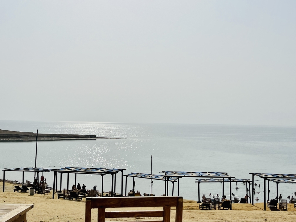 View of a calm sea with beach huts.