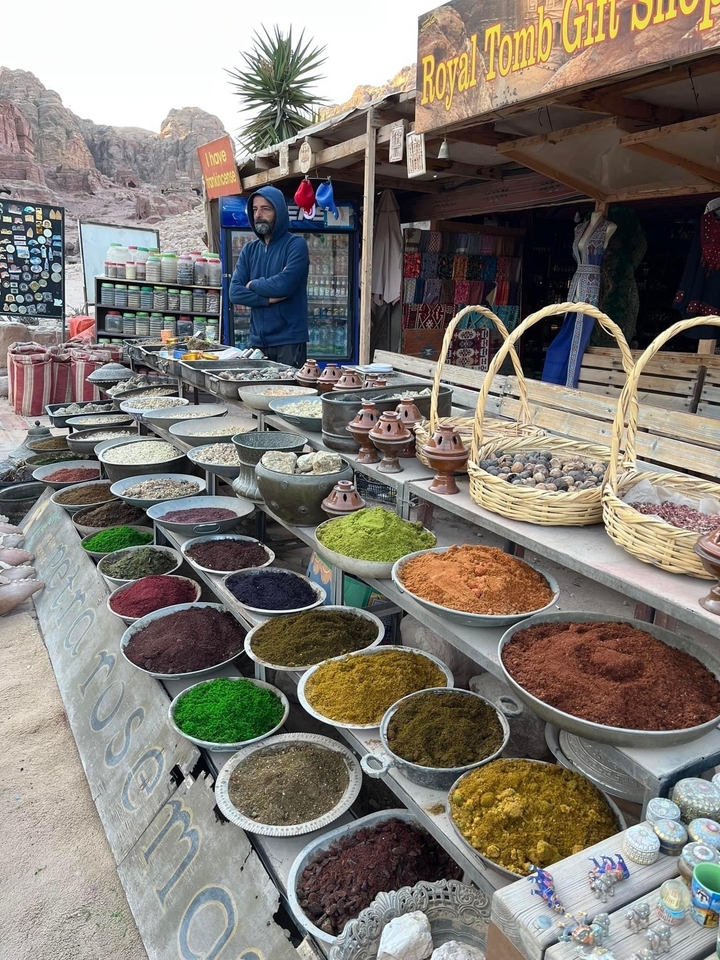 Market stall with bowls of spices.