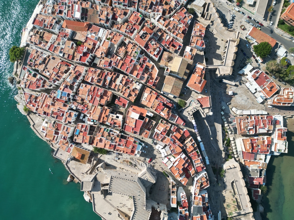Aerial view of a coastal area with tightly packed buildings.