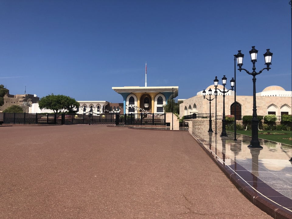 Large building complex with landscaped grounds and lamp posts.