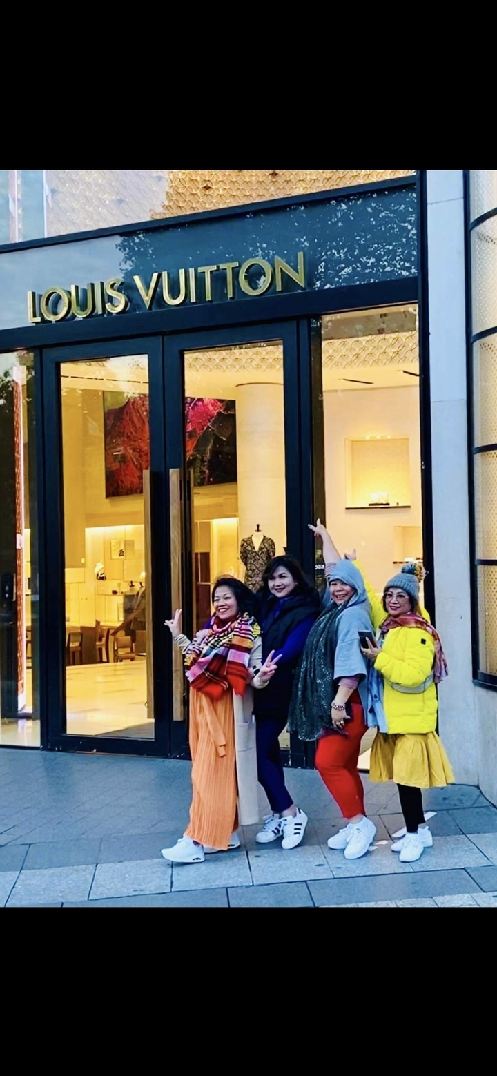 Groupe posant devant un magasin de la ville la nuit.