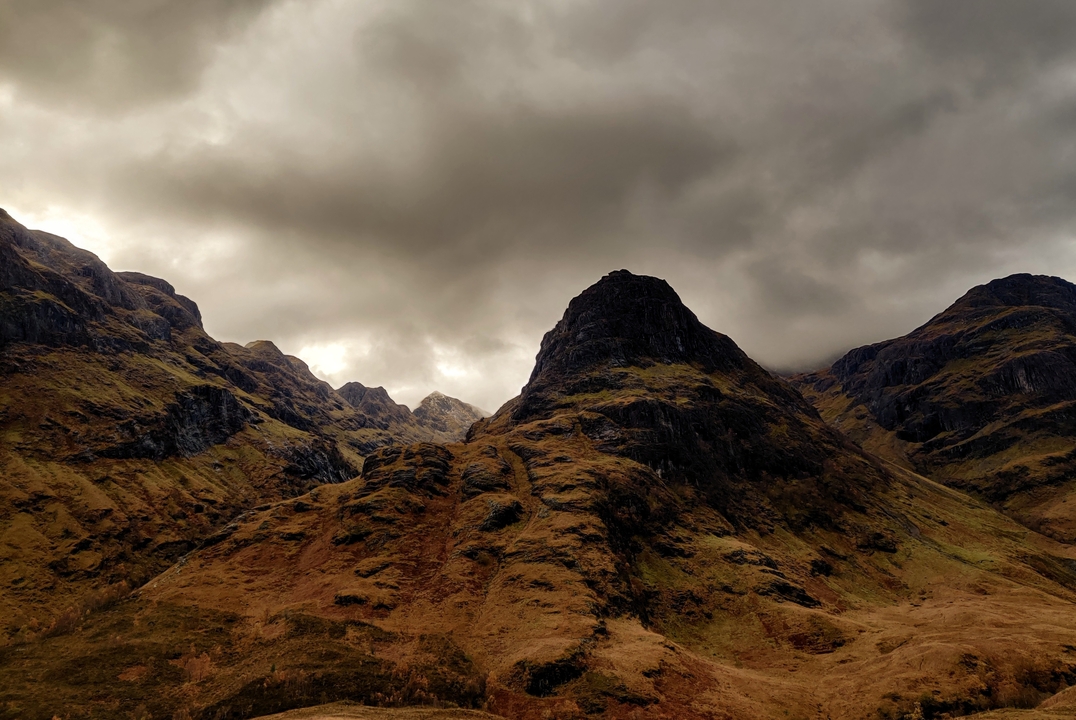 Majestic mountains under a dramatic cloudy sky.