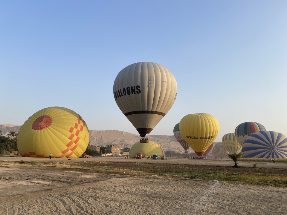 Hot air balloons preparing for flight in a field.
