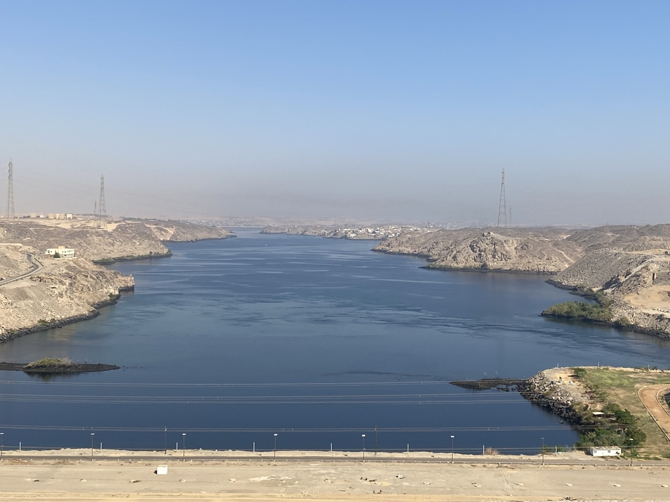 River winding through a desert landscape with towers in the distance.