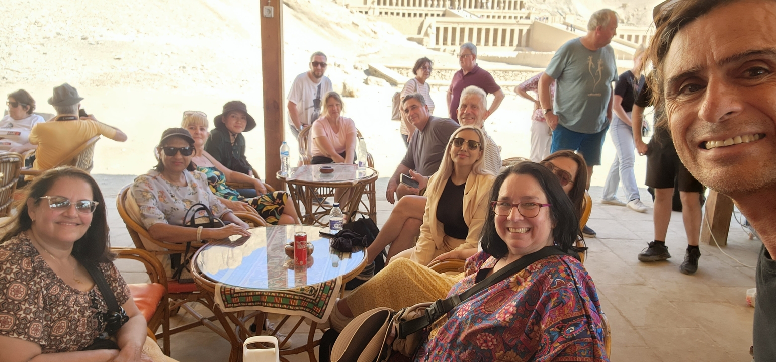 Group of tourists sitting at an outdoor cafe.