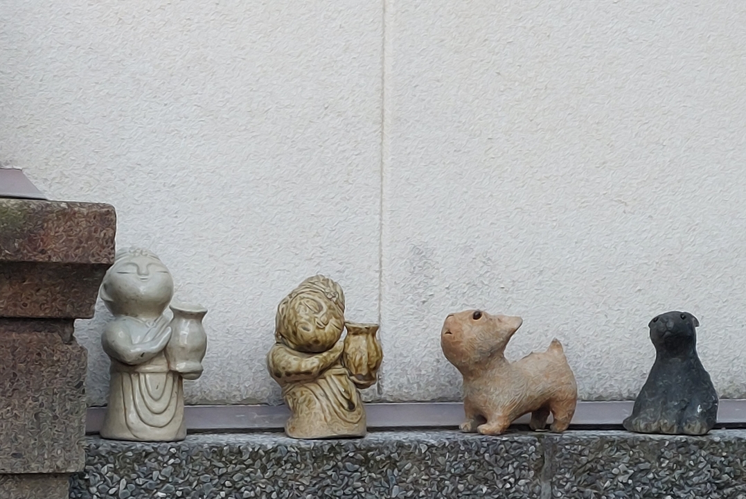 Small stone figures lined up on a surface.
