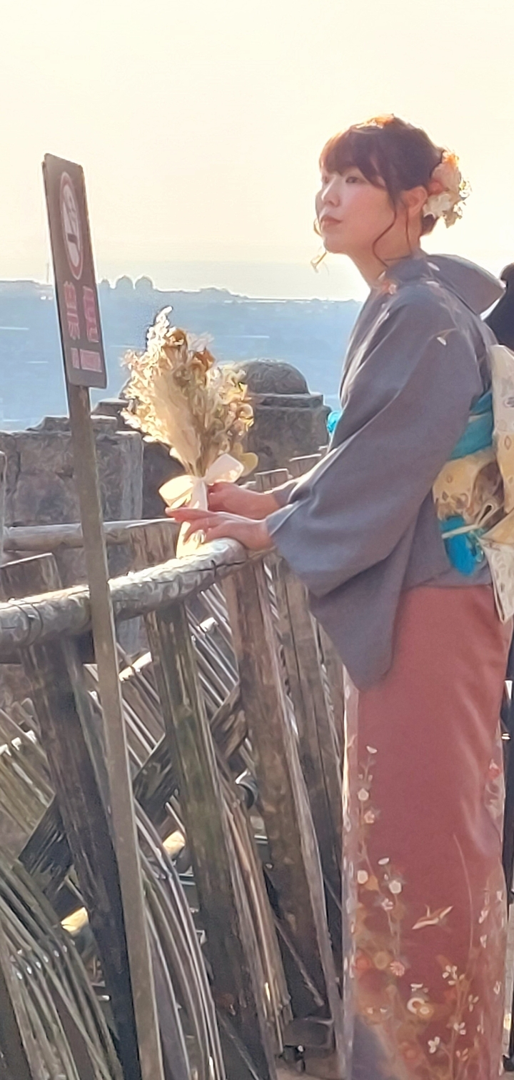 Hands holding flowers near a railing.