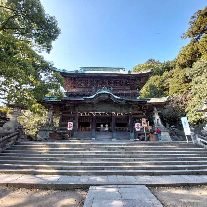Traditional Japanese temple with people at the entrance.