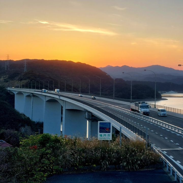 Bridge over a valley with a sunset in the background.