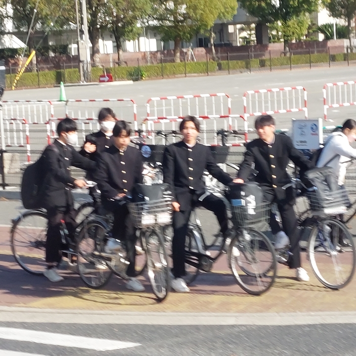 Group of people on bicycles, slightly blurry.