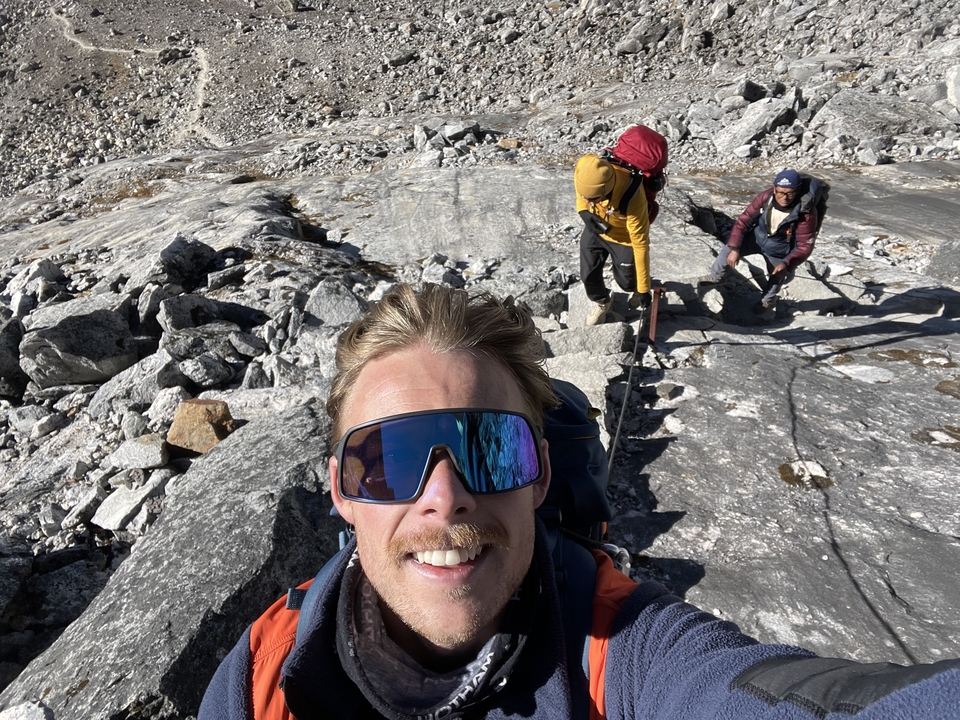 Close-up of hikers on a rocky path in a mountainous area, engaging in an adventure.