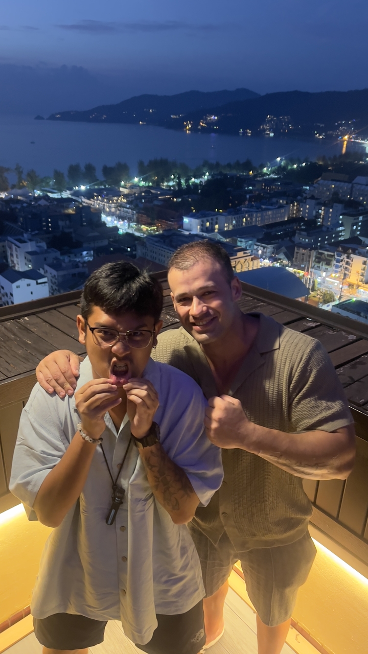 Two people posing playfully on a rooftop.