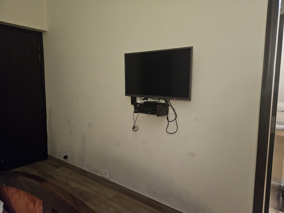 Empty wall with a mounted TV in a room.