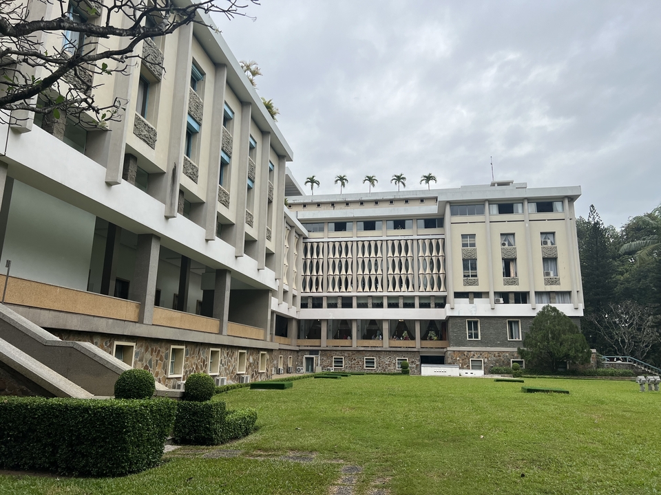 Modernist building with a garden in front.