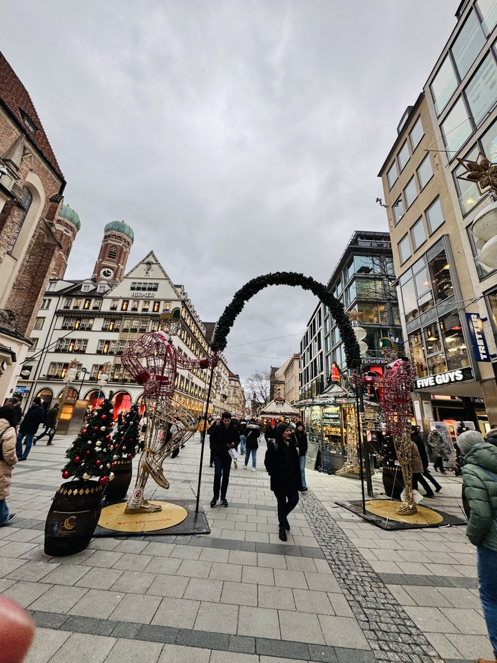 A bustling street with Christmas decorations and architecture.