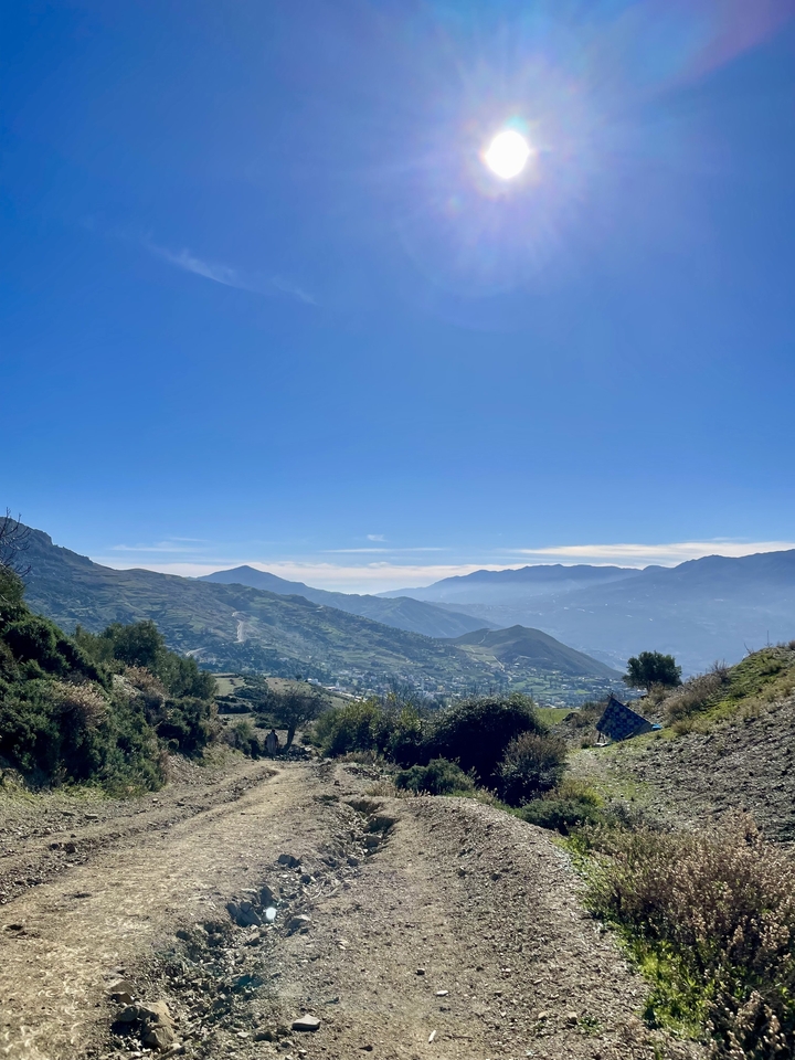 Panoramic mountain landscape under a clear blue sky.
