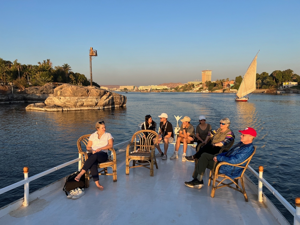 Group of people relaxing on a boat during a river cruise.