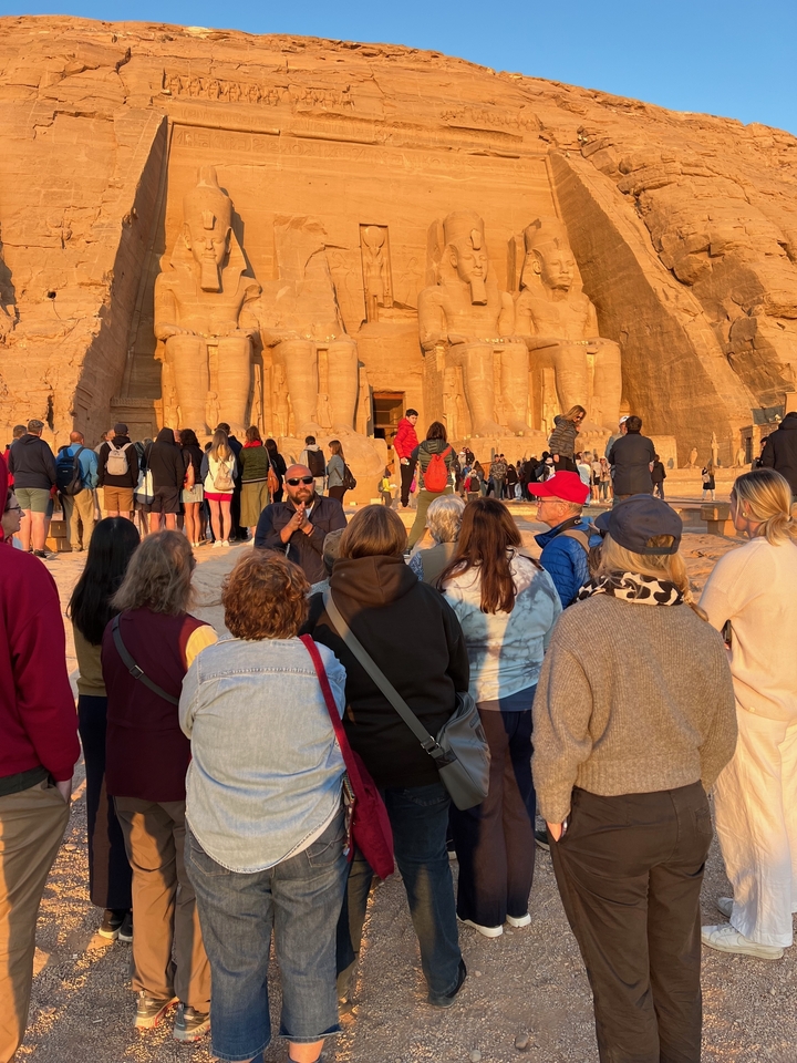 Tour group at Abu Simbel under a warm sun.