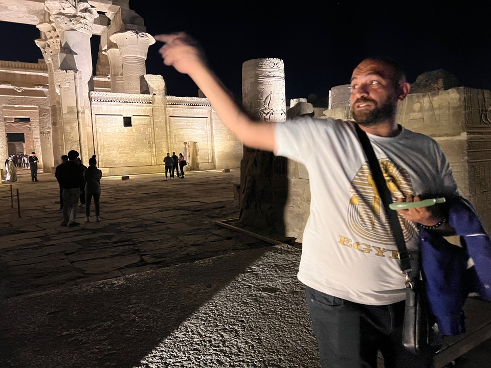 Night tour at an ancient temple site, with a guide explaining.