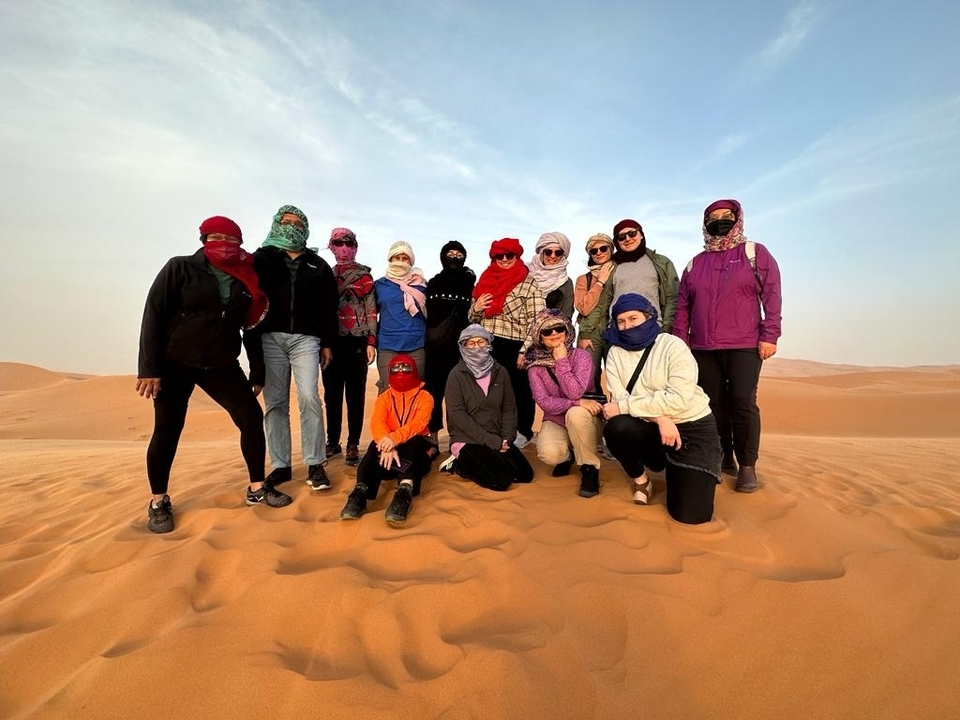 Group of people posing in the sand dunes