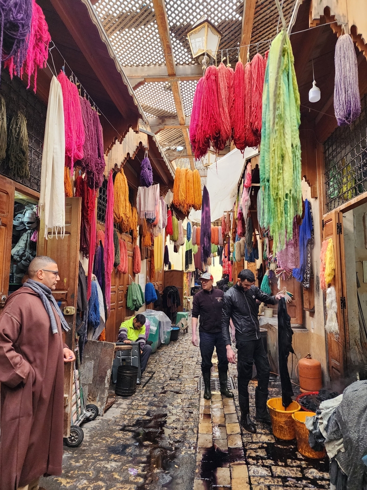 Market street with colorful fabrics and people