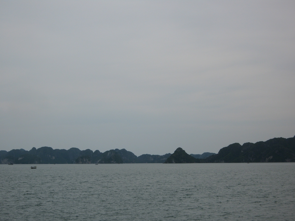 Distant view of karst formations against overcast sky.