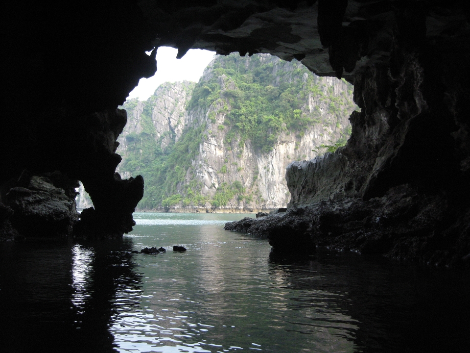 View from inside a cave looking out to limestone cliffs
