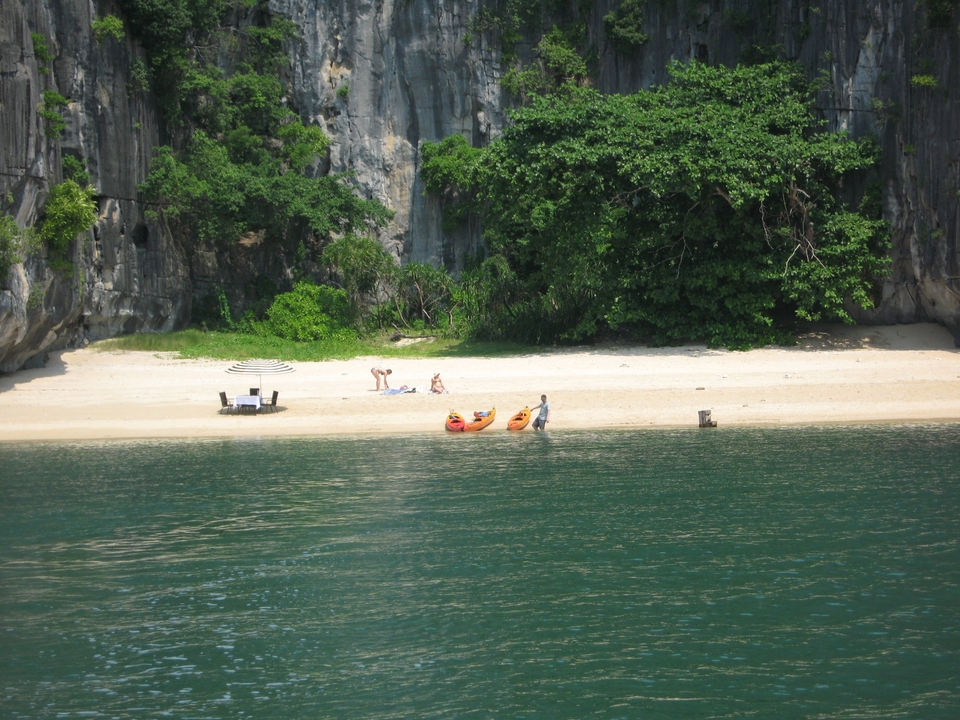 Beach with kayaks and people relaxing