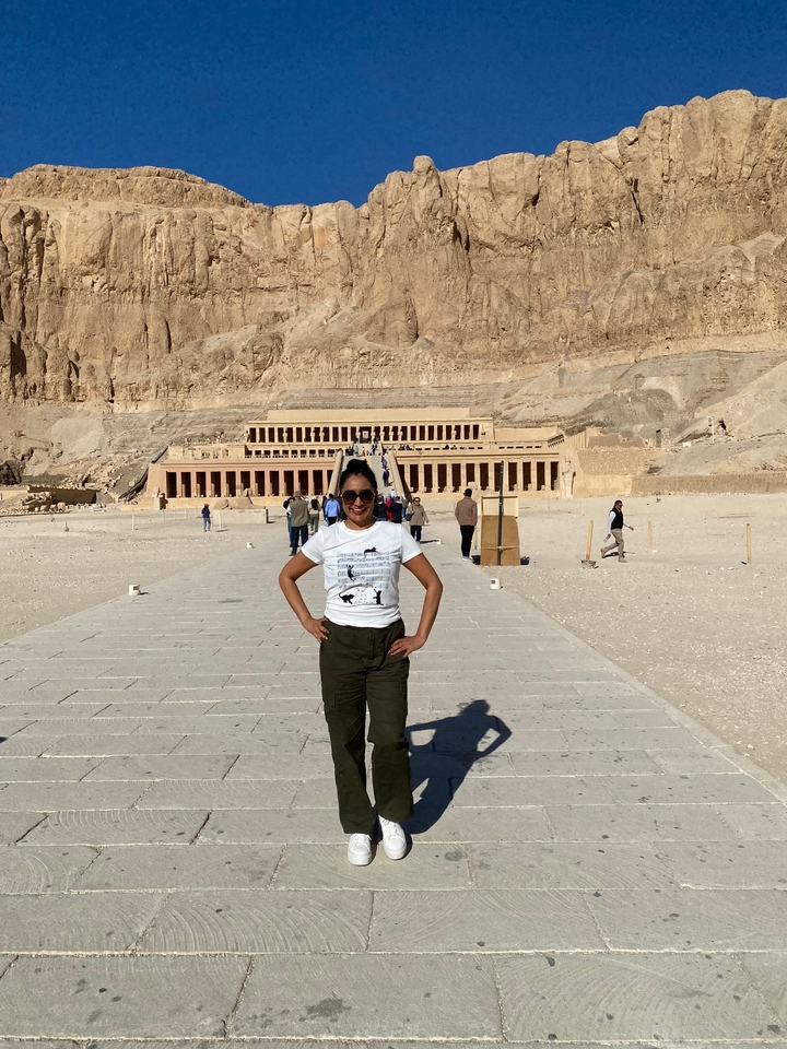 Personne posant devant le temple funéraire d'Hatchepsout.