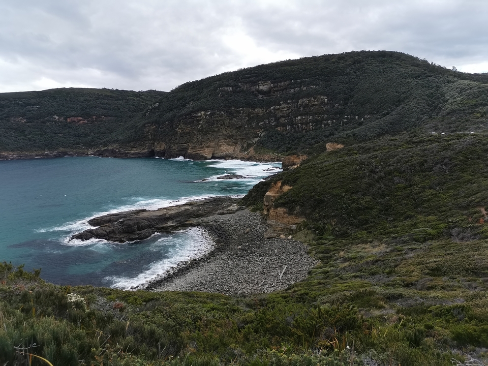 Coastline with rocky shore and ocean waves.