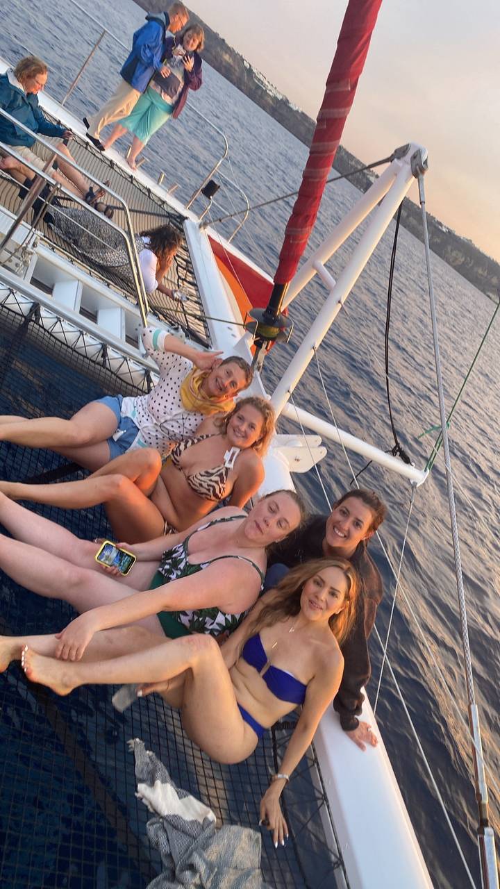 Group of people relaxing on a boat on the water.