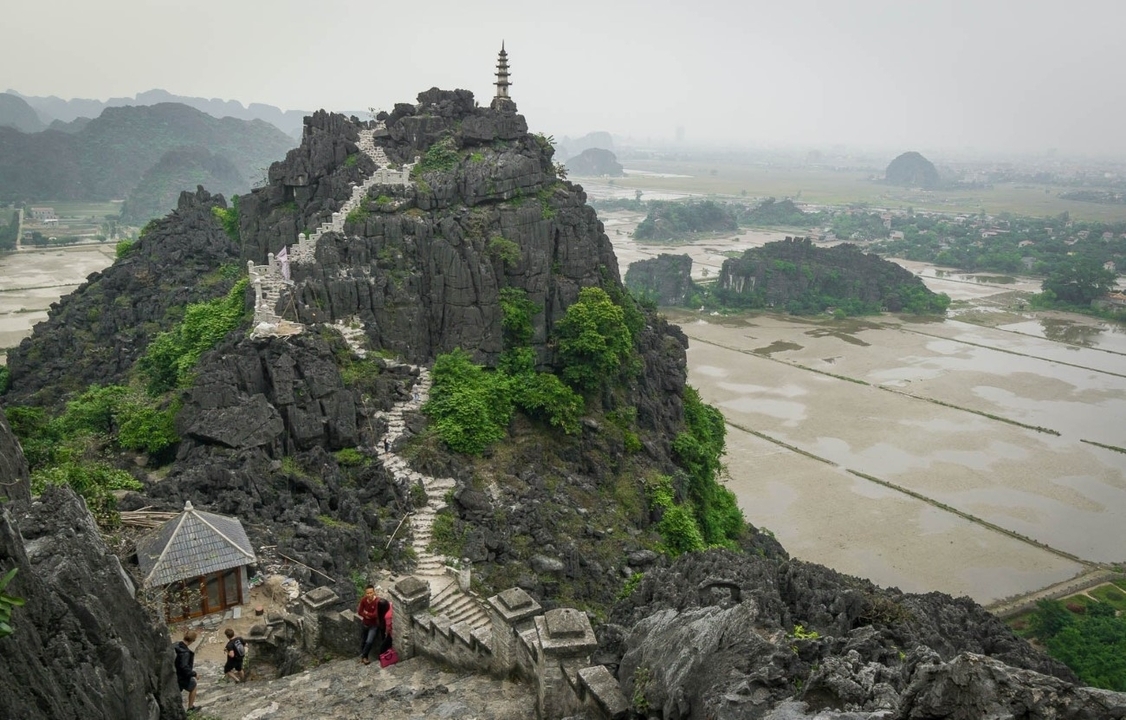 Mountainous landscape with a winding stone staircase.