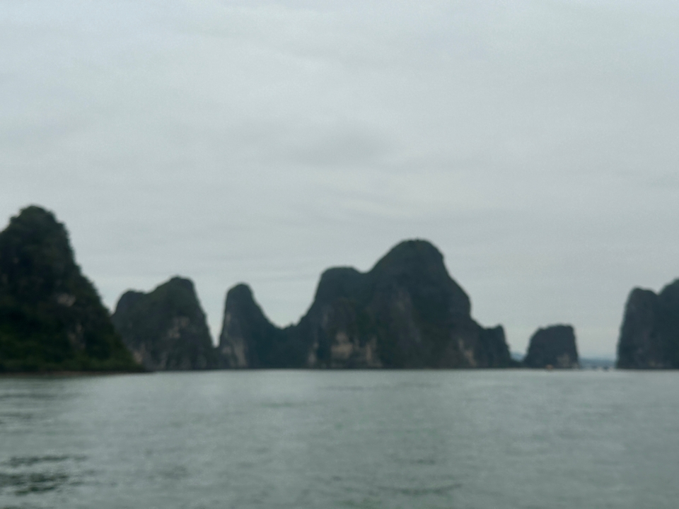 Blurry view of cliffs over the sea.