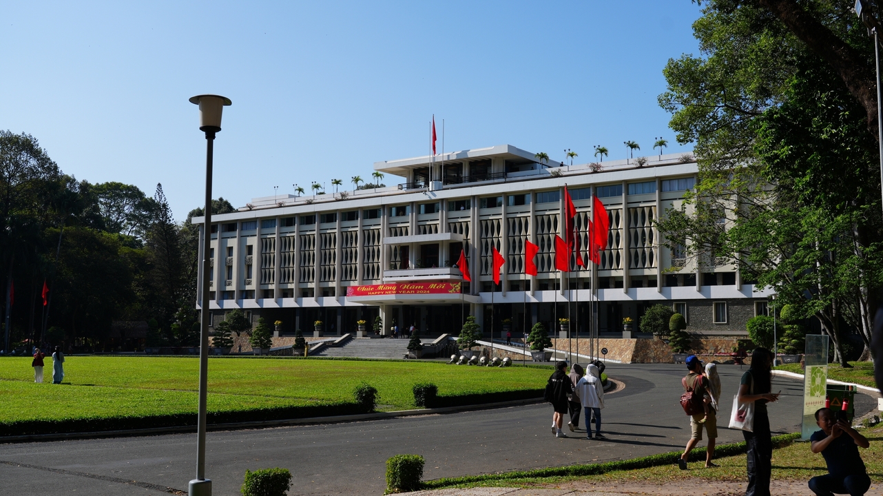 Government building with flags and manicured landscape.