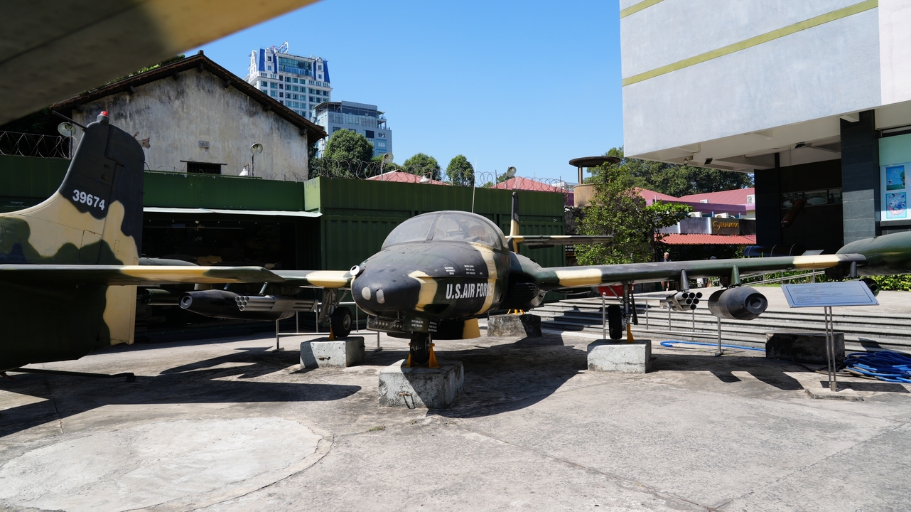 Outdoor display of a military aircraft in a museum setting.