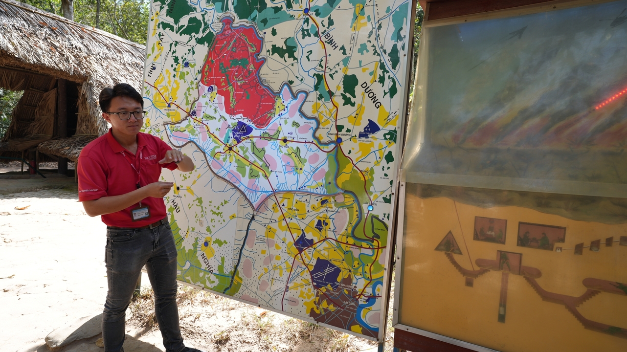Man explaining a colorful map outdoors.