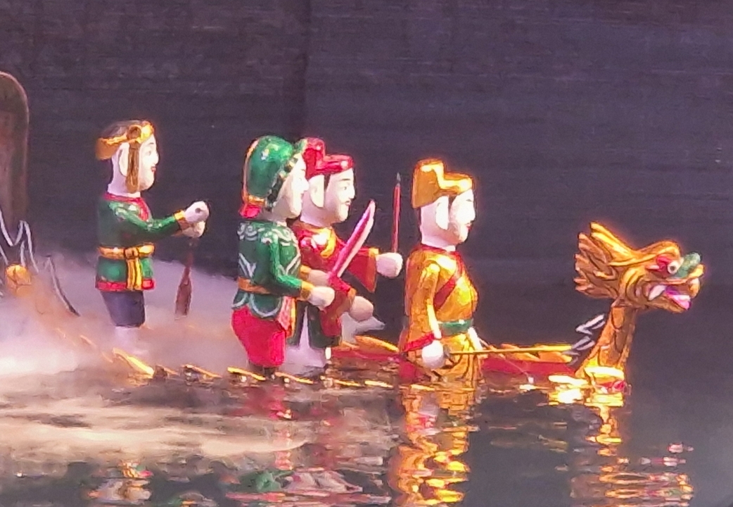 Traditional water puppets with colorful costumes.