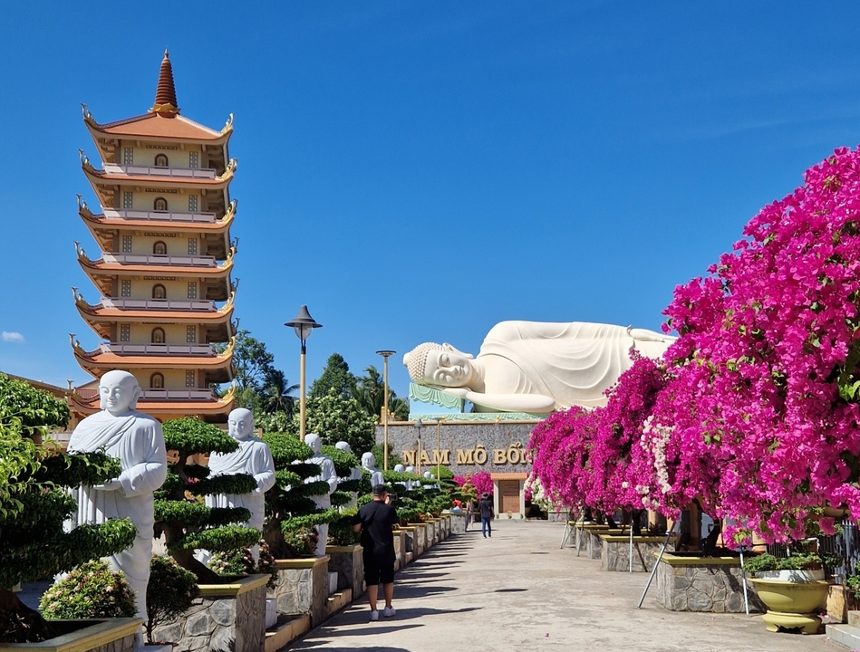 Temple with pagoda and reclining Buddha statue.