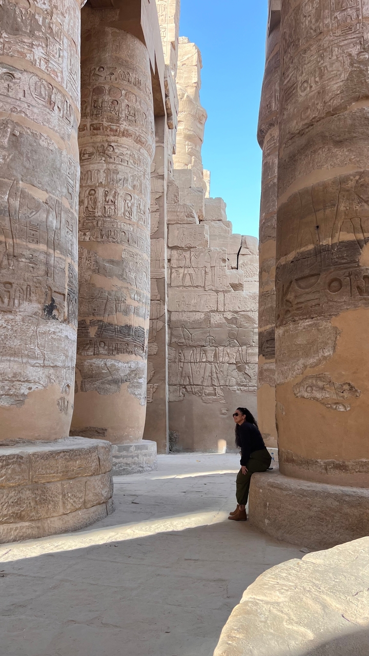 Ancient temple ruins with large inscribed columns.
