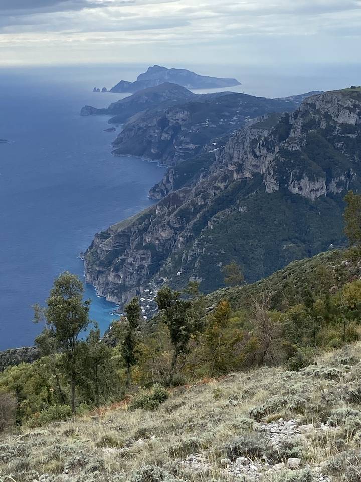 A panoramic view of a coastal cliffside and ocean.