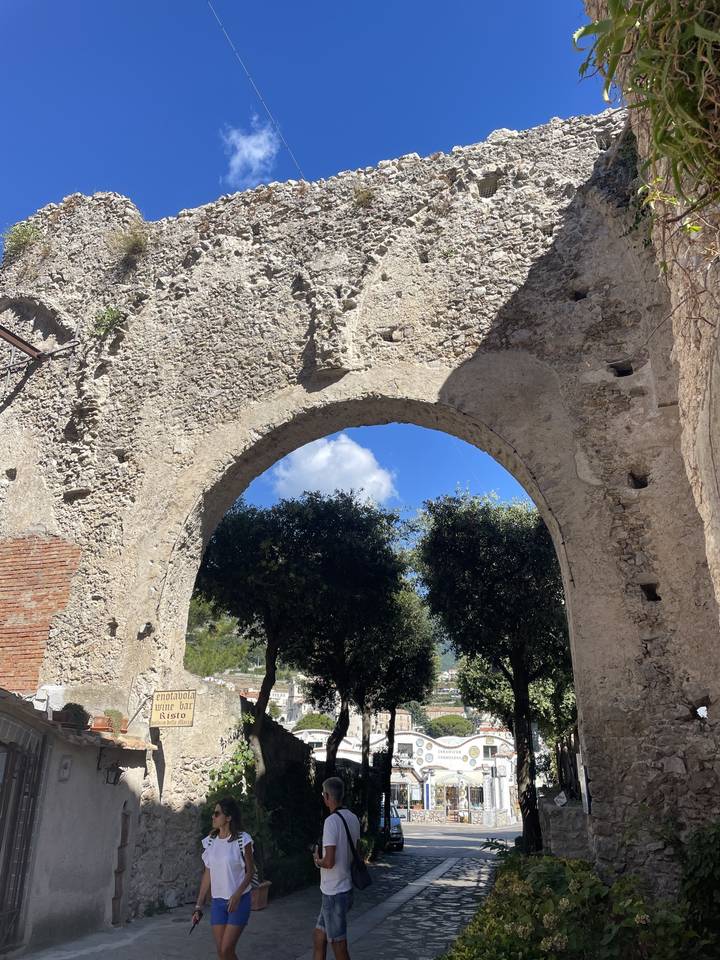 Archway ruins with a view of a city square
